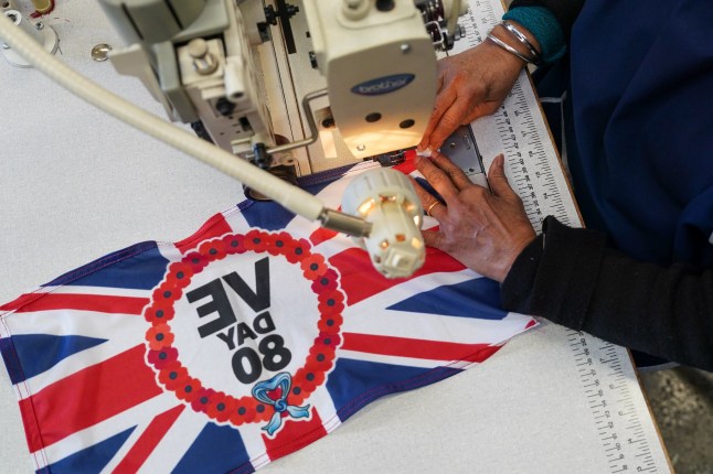 LEEDS, ENGLAND - MARCH 18: Flags are made at the JW Plant Flag Company ahead of the VE Day 80th anniversary on March 18, 2025 in Leeds, England. JW Plant & Co. Ltd. was founded in 1908 and is one of the most respected and trusted flag manufacturers in the UK. For three generations, the skills and expertise needed to establish a manufacturer of quality have been passed down and developed within this successful family business. Victory in Europe Day is the day celebrating the formal acceptance by the Allies of World War II of Germany's unconditional surrender of its armed forces on Tuesday, 8 May 1945. It marked the official surrender of all German military operations. A series of celebrations and commemorations are due to take place across the country to mark the anniversary. (Photo by Ian Forsyth/Getty Images)