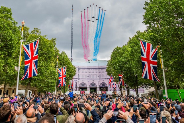 Mandatory Credit: Photo by Guy Bell/Shutterstock (15284471h) Nine Red Arrows Hawk 11 aircraft with four Typhoons with red white and blue smoke - Crowds fill the mall but no flags are waved as everyone is too busy filming it on their mobile phones. The flypast down the Mall after The VE Day 80th anniversary military procession. It marks the anniversary of Victory in Europe day which was the end of World War Two in the european arena. VE Day Flypast, The Mall, London., UK - 05 May 2025