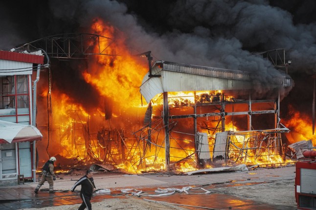 Firefighters work at the site of the Barabashovo market hit by Russian drone strike, amid Russia's attack on Ukraine, in Kharkiv, Ukraine May 6, 2025. REUTERS/Viktoriia Yakymenko