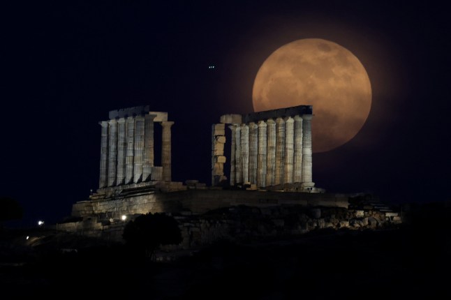 The full moon, known as a "Flower Moon" rises behind the Temple of Poseidon in Cape Sounion, near Athens, Greece, May 12, 2025. REUTERS/Louisa Gouliamaki TPX IMAGES OF THE DAY