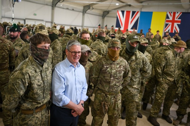 Prime Minister Sir Keir Starmer poses for a photo with troops during a visit to a military base training Ukrainian troops in the West of England. Picture date: Tuesday April 22, 2025. PA Photo. See PA story POLITICS Ukraine. Photo credit should read: Finnbarr Webster/PA Wire