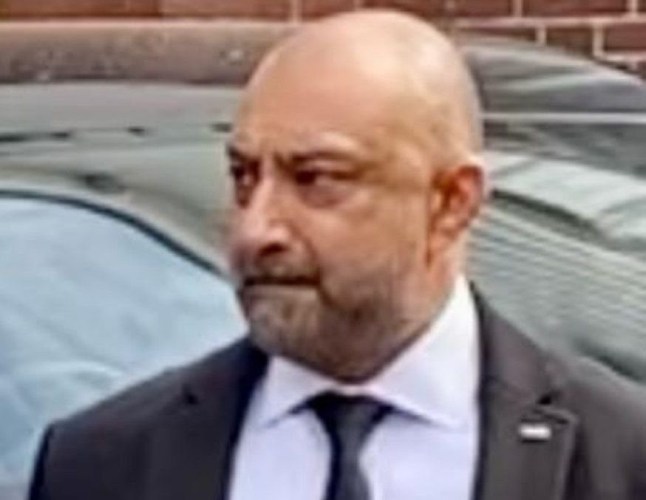 Nin Rehal dressed in a suit and tie.