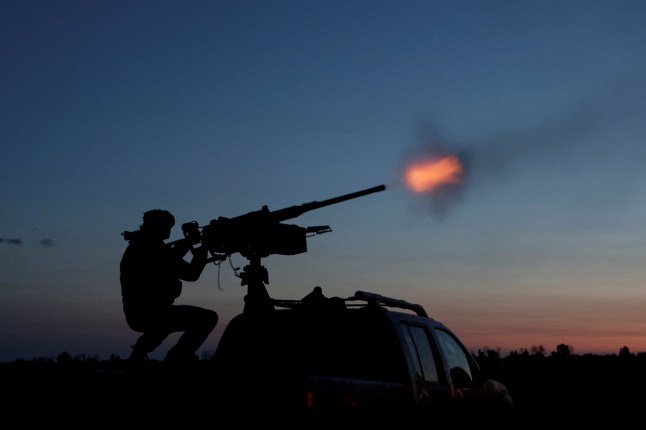 A serviceman from the mobile air defence unit of the 115th Separate Mechanized Brigade of the Ukrainian Armed Forces fires a Browning machine gun towards a Russian drone during an overnight shift, amid Russia's attack on Ukraine, in Kharkiv Region, Ukraine June 2, 2025. REUTERS/Sofiia Gatilova