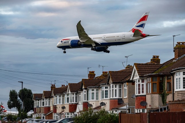 A British Airways plane gliding above houses near Heathrow.