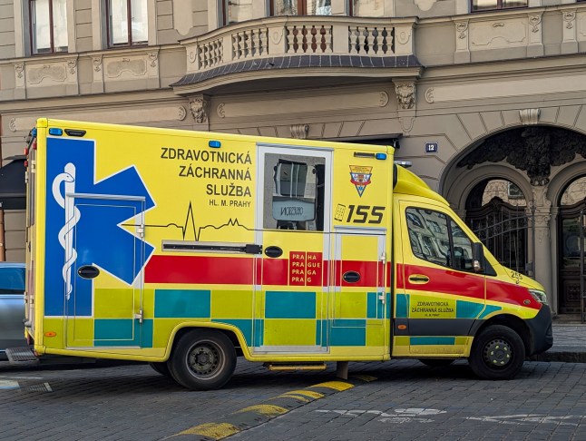 A yellow-red ambulance of the Emergency Medical Services of Prague parks on a city street in Prague, Czech Republic, on May 11, 2025. The vehicle is part of the city's urgent response system and is marked with emergency number 155. (Photo by Michael Nguyen/NurPhoto via Getty Images)
